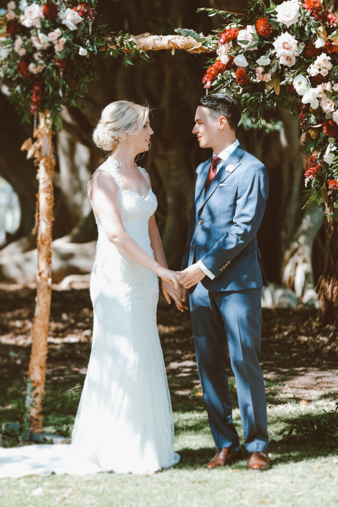 bride and groom smiling and holding hands at their wedding at Tocal Homestead