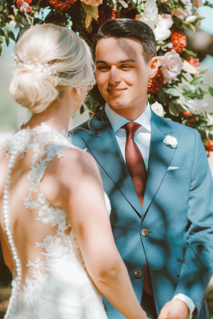 Groom looking at bride while smiling