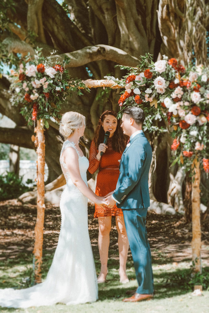 Hunter Valley Wedding Venue Tocal Homestead Celebrant Julie Muir talking to bride and groom who are holding hands mid-ceremony