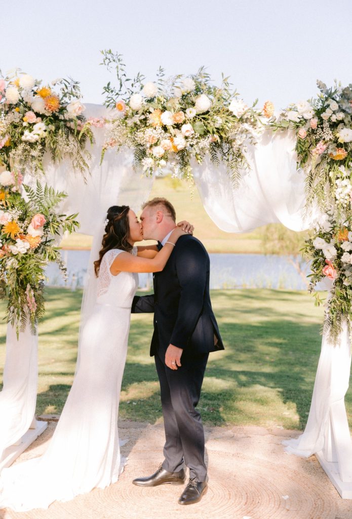 First kiss under stunning arbour at Willow Tree Estate