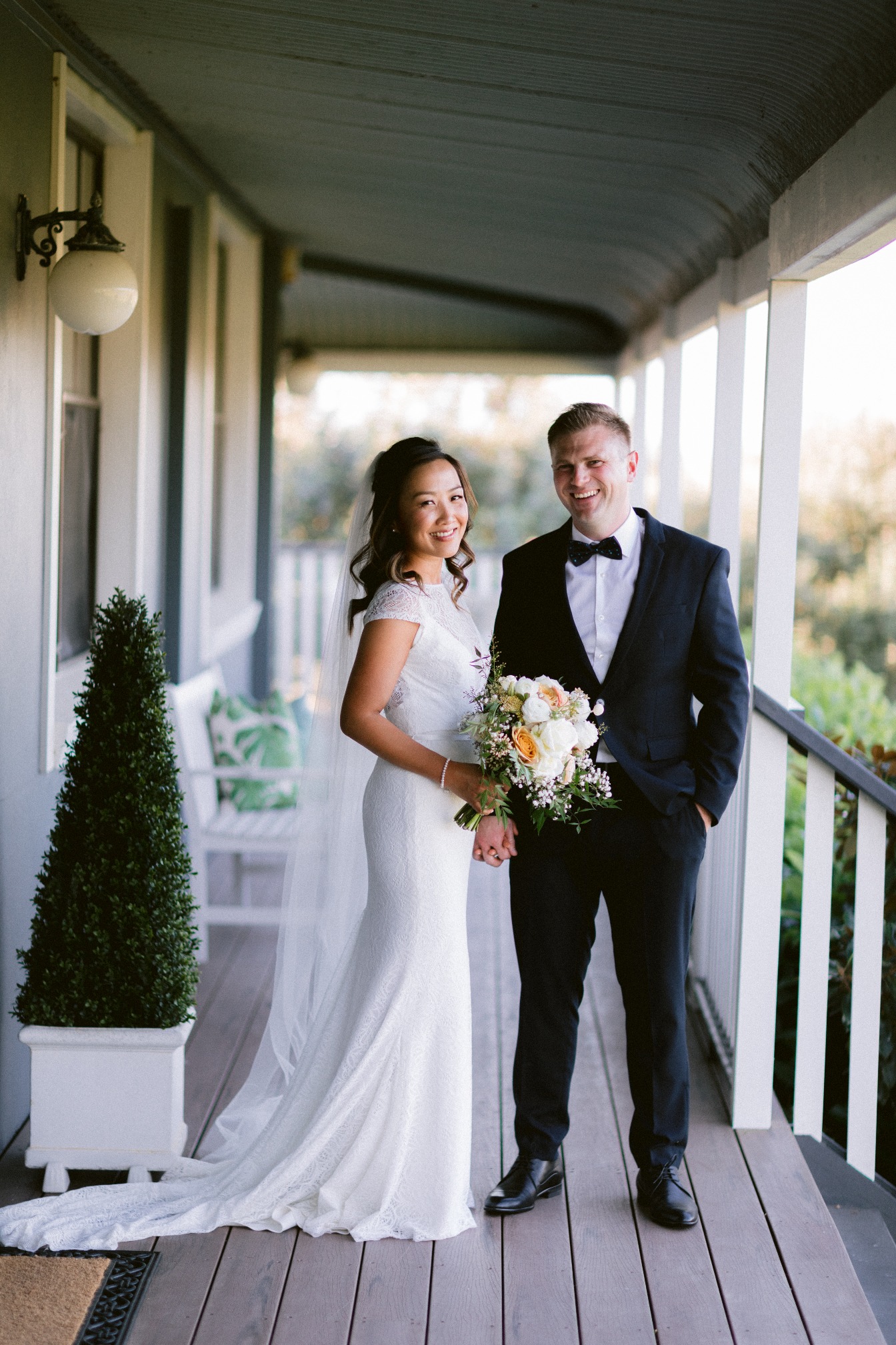 Bride and groom on a porch at Willow Tree Estate