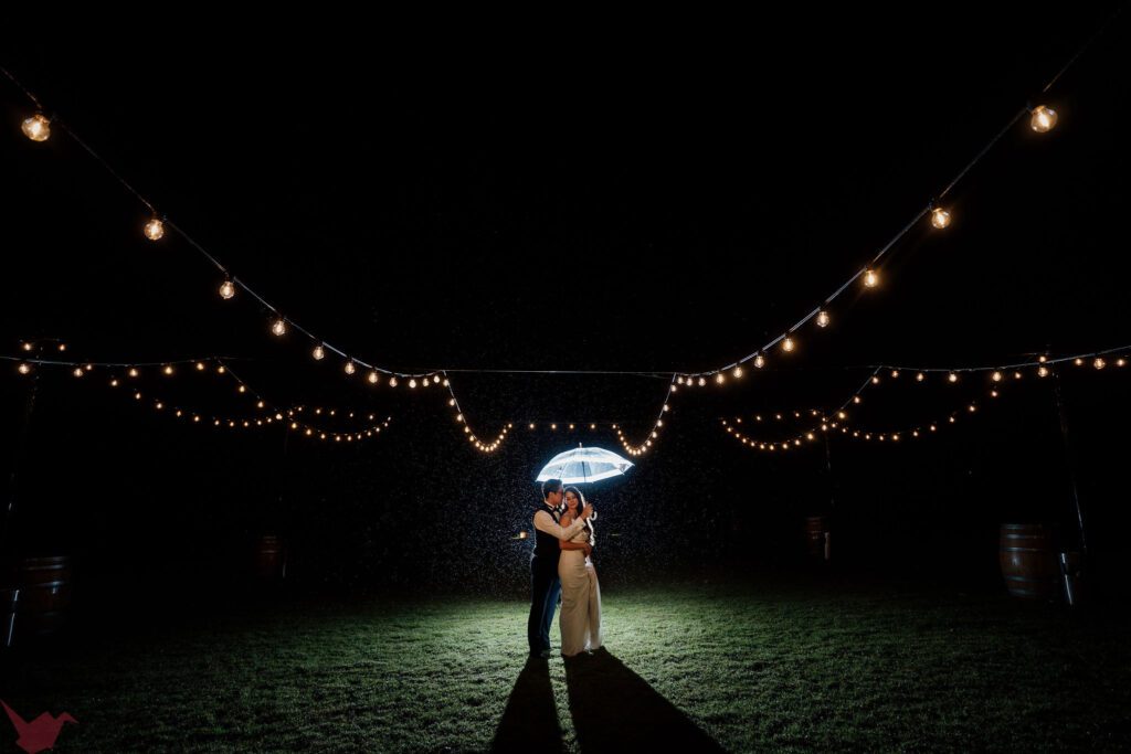 Couple dancing in the rain at night time at Hunter Valley Wedding Venue Anambah House