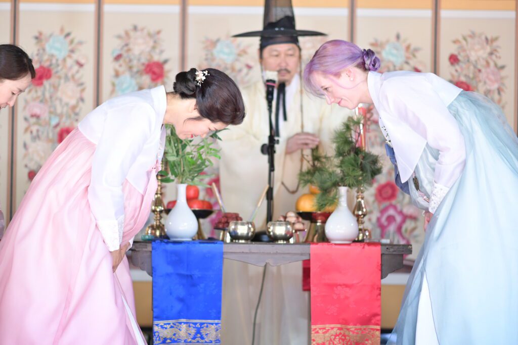 Blending the families- one of the challenges facing couples.. Two mothers bow during traditional Korean wedding