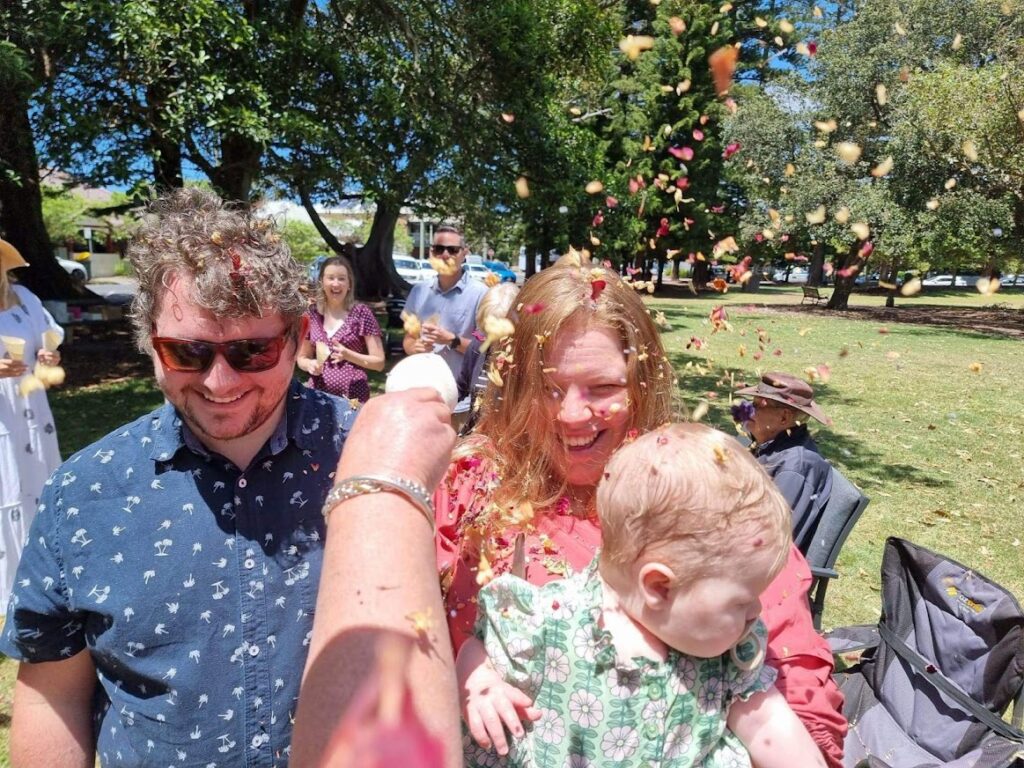 Couple and baby getting showered with eco-confetti at Newcastle baby naming