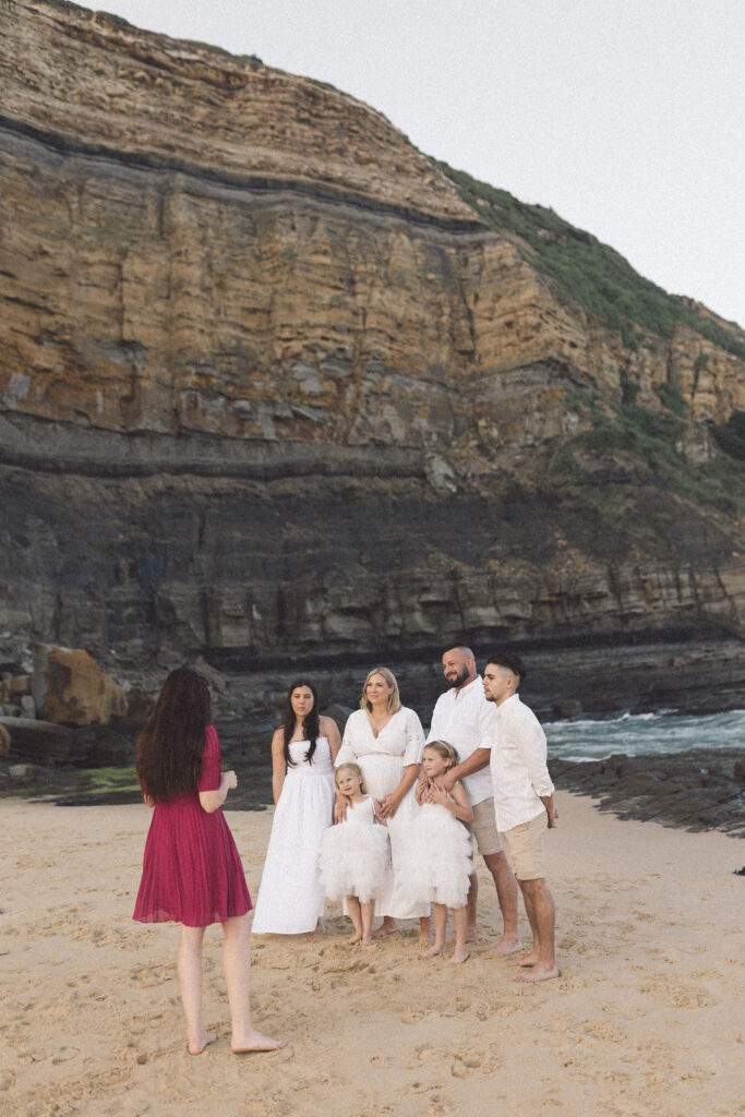 Family and celebrant standing on the sand for Bar Beach Elopement