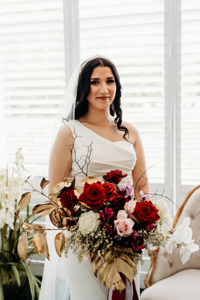 Bride smiling while holding her bouquet