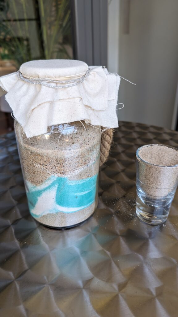 Sand pouring jar with coloured sand for Baby Naming Medowie at Pacific Palms Golf Club