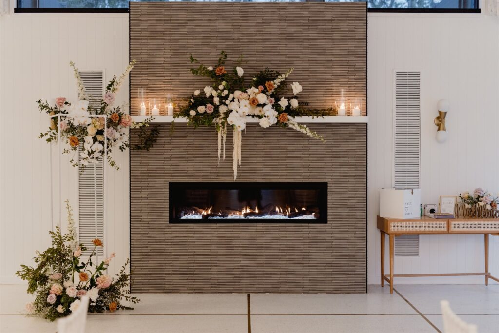 External fireplace decorated with candles and flowers