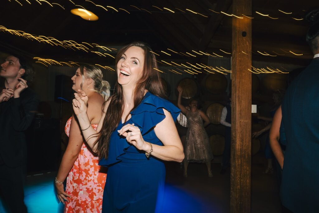 Celebrant Julie Muir dancing happily at a wedding reception