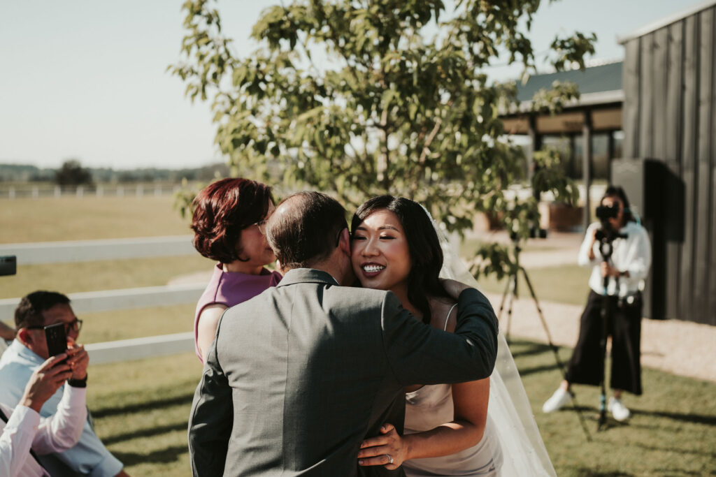 Bride hugging a wedding guest