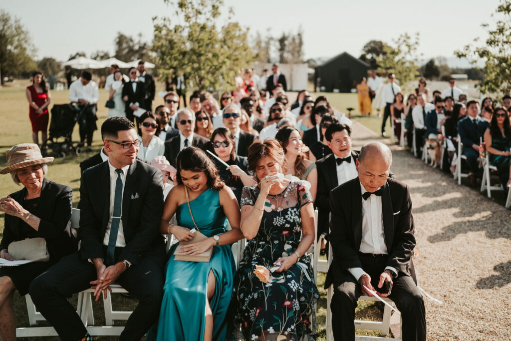 Wedding guests sitting and waiting at an outdoor wedding at Dark Horse Vineyard