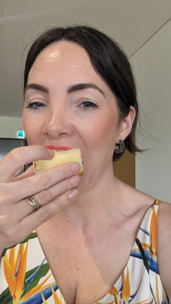 Celebrant Julie Muir taking a bite of a slice of cake