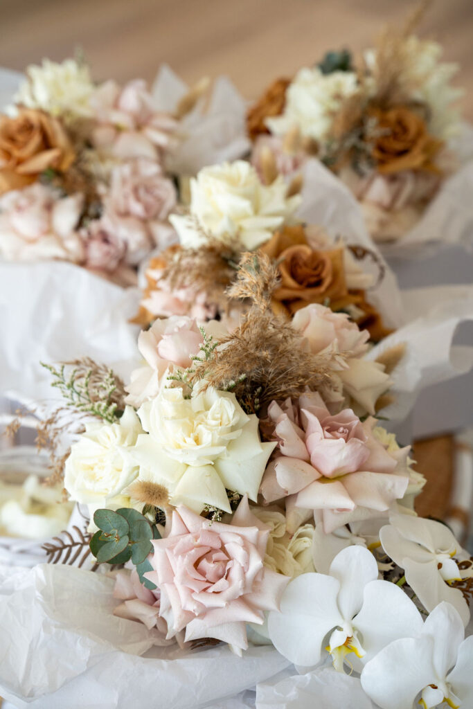 Pastel-themed floral centerpieces on a white table