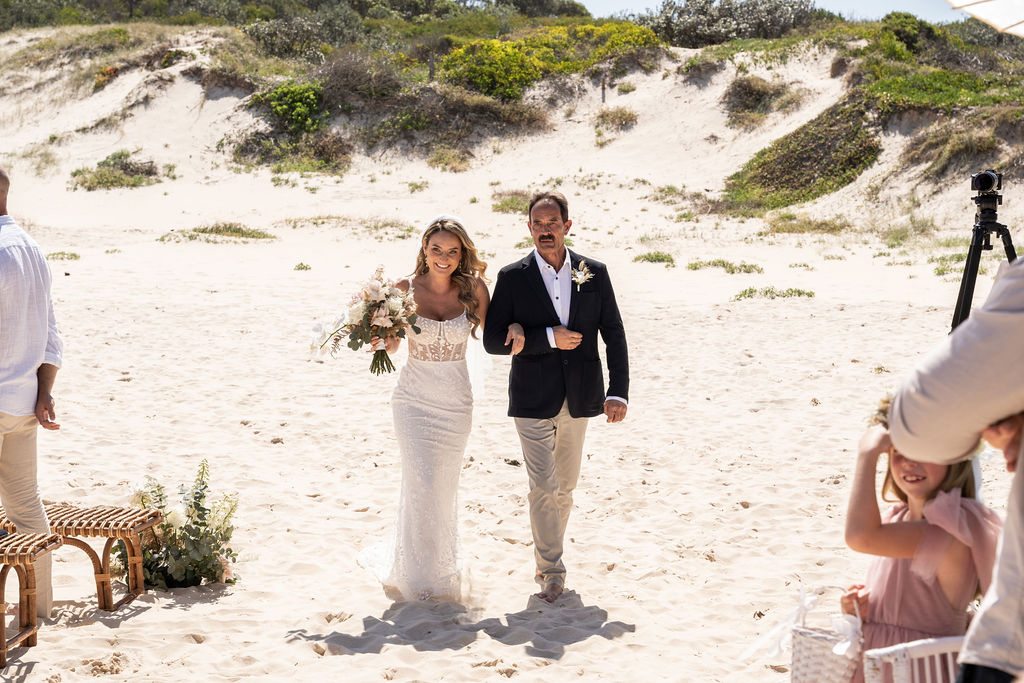 Bride and her father walking down the aisle at Zenith Beach