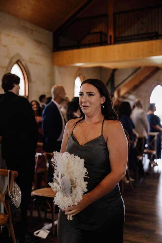 Bridesmaid walks down the aisle with tears at Peterson House Chapel