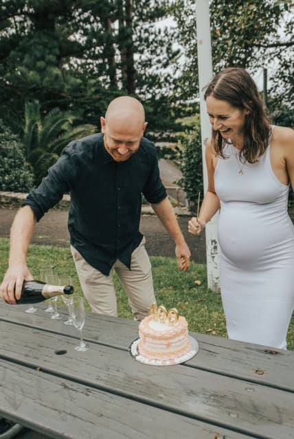 Groom pours champagnes to have with cake for King Edward Park Elopement