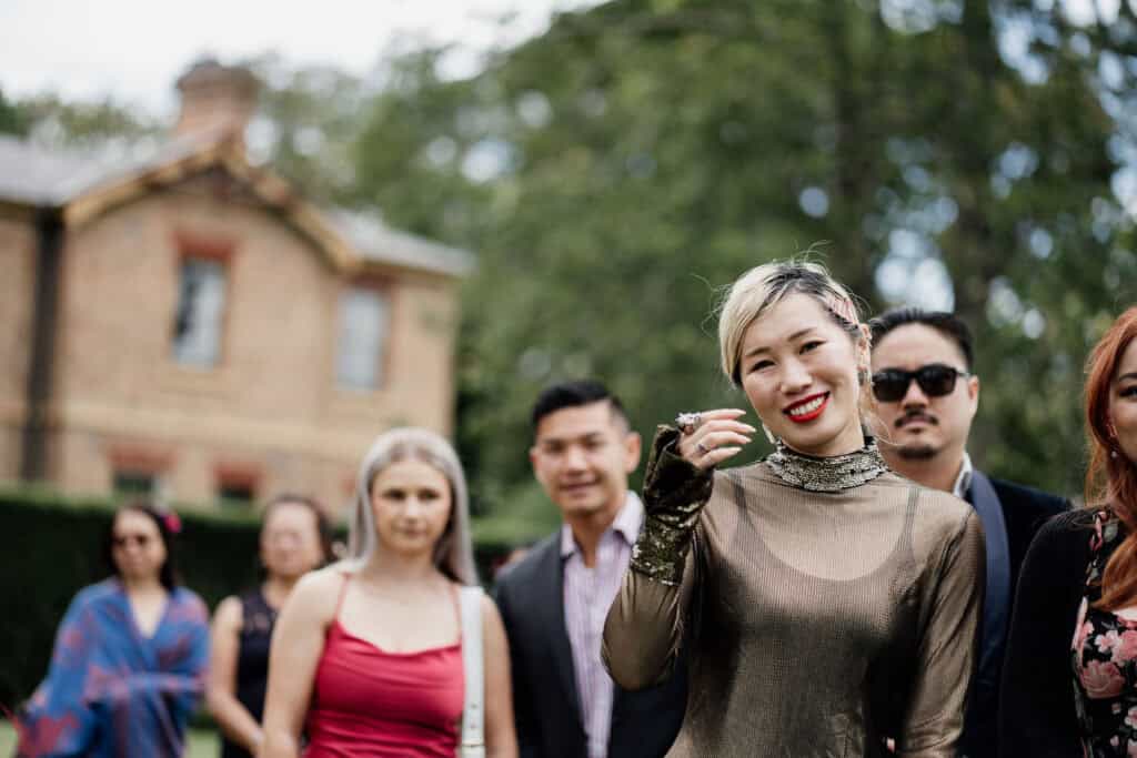 Stylish guest smiles in metalic dress at Anambah House wedding ceremony