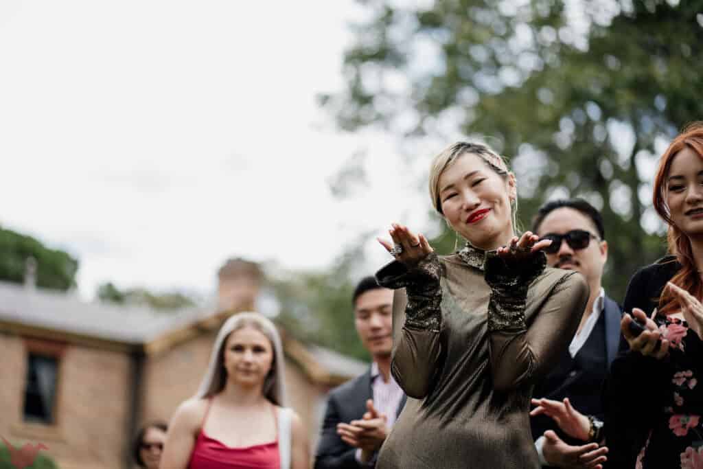 Guest blows kiss to the couple during wedding ceremony at Anambah House