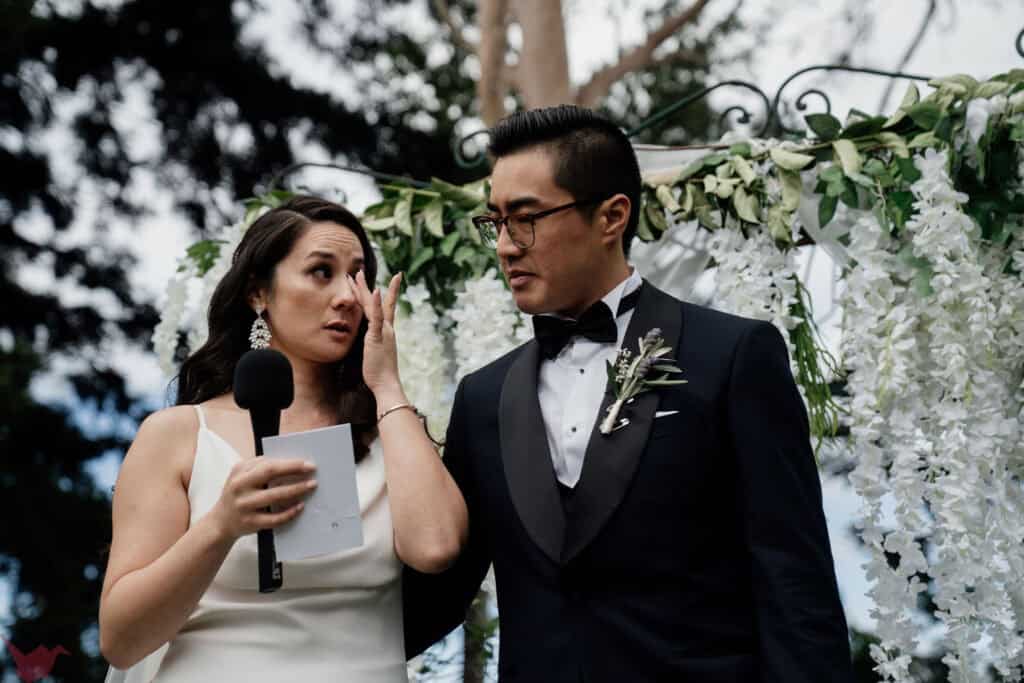 Bride wipes a tear from her eyes during her vows at Anambah House