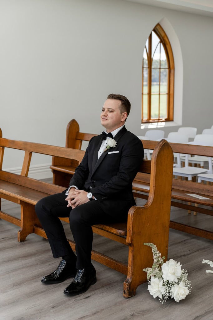 Groom sitting composing himself before his wedding at Chapel Ridge