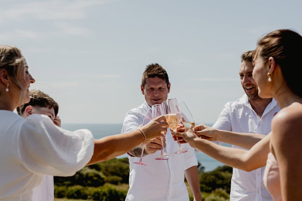 Toasting to the newlyweds after  Newcastle coastal wedding