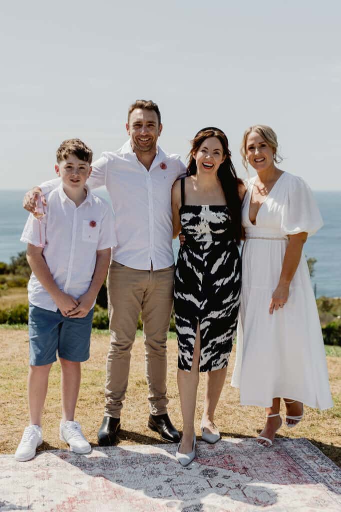 Celebrant Julie Muir standing with couple after their Newcastle coastal wedding