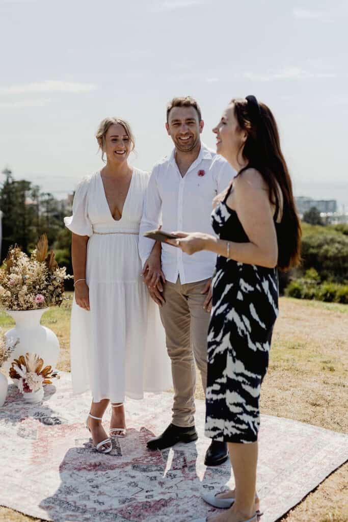 Celebrant and couple smile for  Newcastle coastal wedding