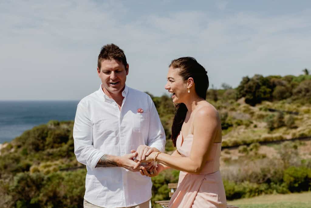 Friends embue the rings with love at  Newcastle coastal wedding