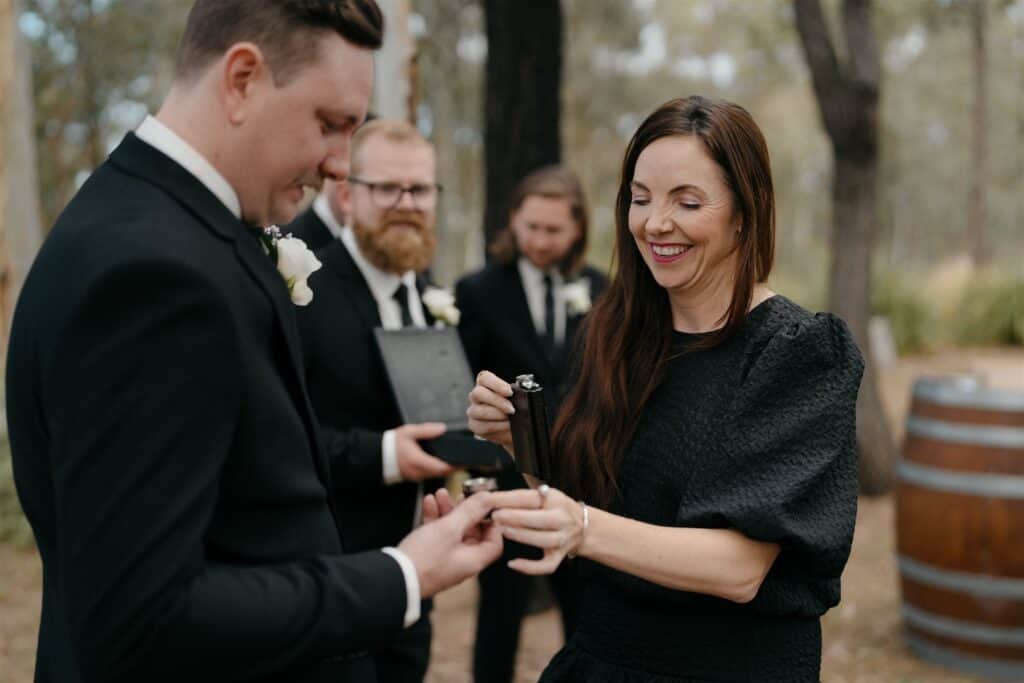 Celebrant Julie Muir drinking whiskey with the groom at The Wine House