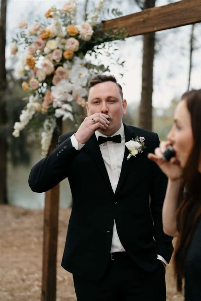 Celebrant Julie Muir doing a whiskey shot with groom before wedding at The Wine House