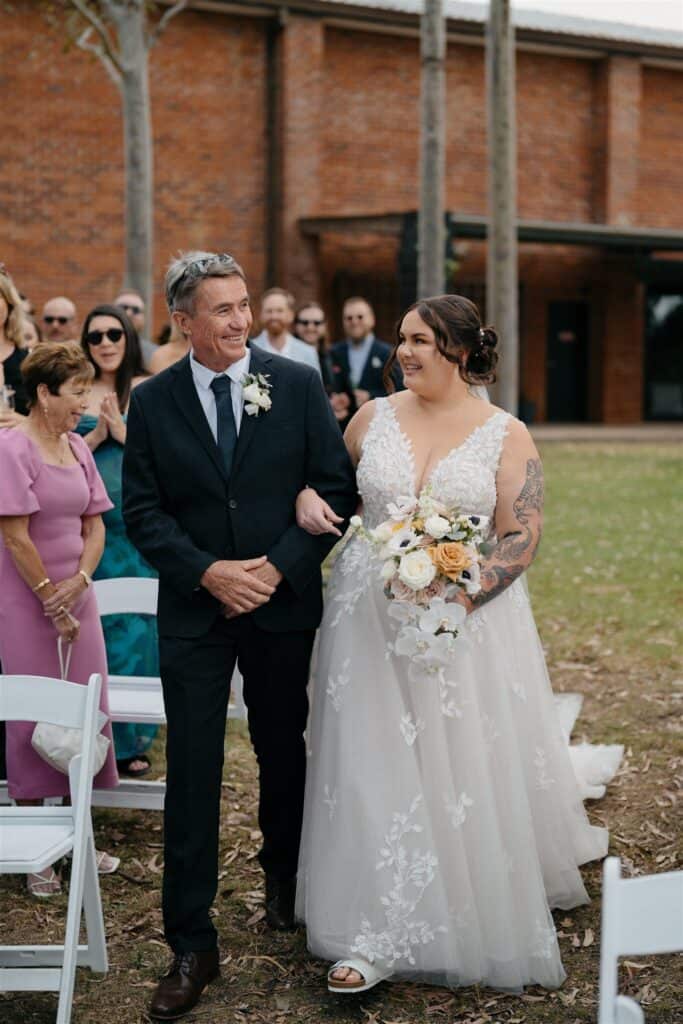 Bride walks down the aisle in Birkenstocks with father at The Wine House