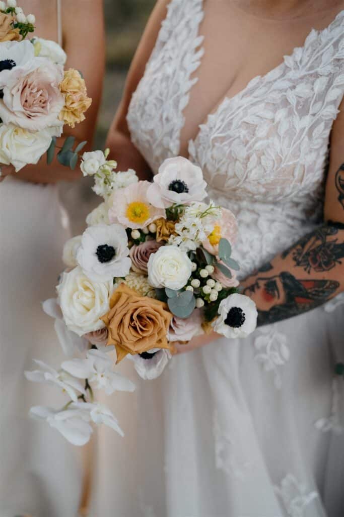 Stunning pastel wedding bouquet held my bride with sleeve tattoo. 