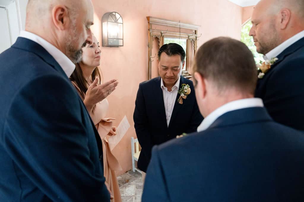 Celebrant Julie Muir leading groomsmen in a pre wedding meditation at Redleaf Wollombi