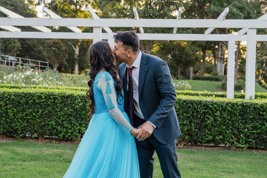 Kiss on the cheek at Jesmond Park wedding