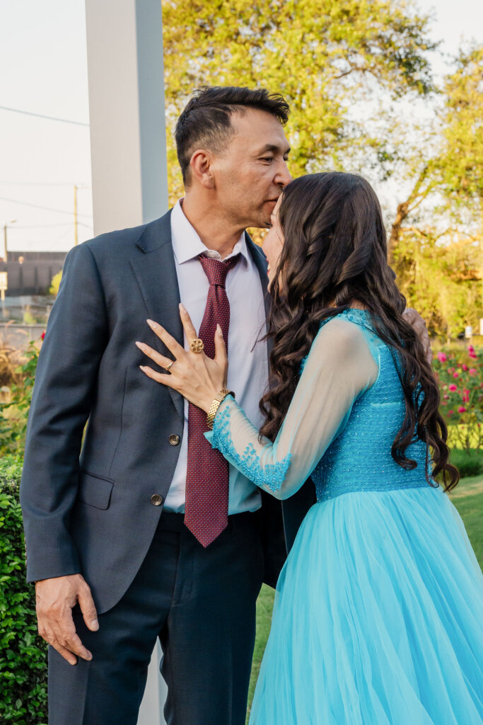 Afghan groom kisses forehead of bride at Jesmond Park wedding