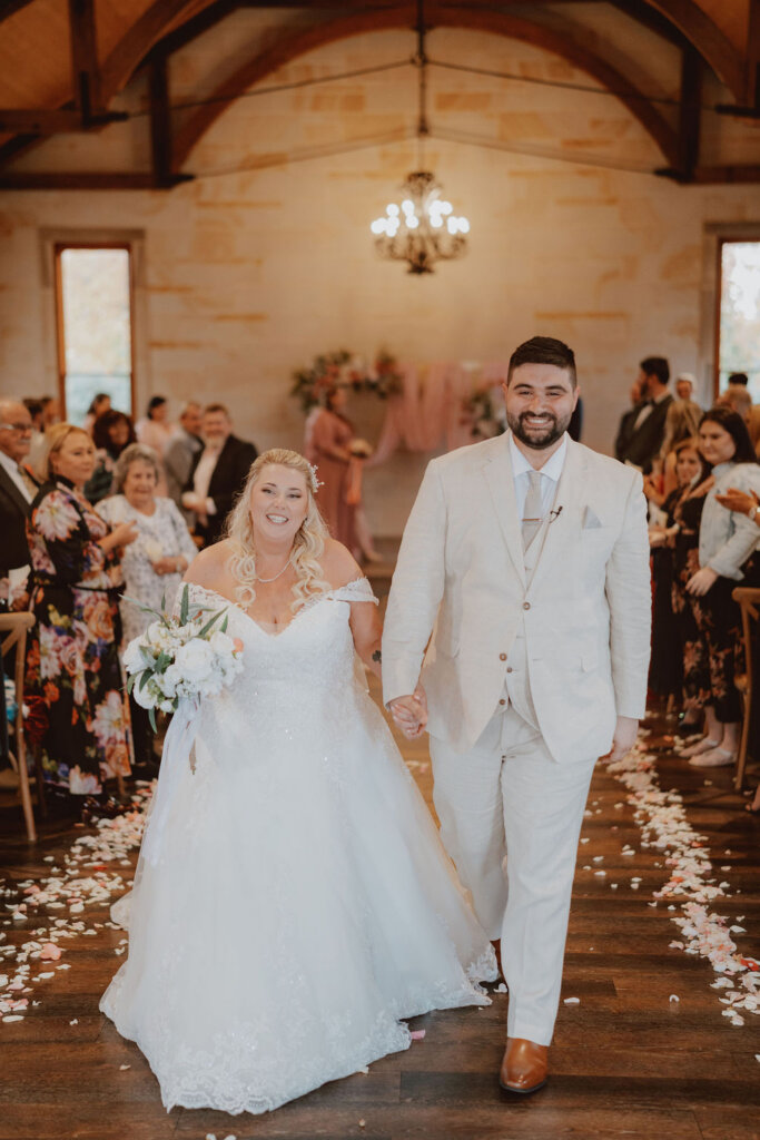 bride-and-groom-exiting-the-alter-after-the-ceremony-rachel-and-nick-macedonian-wedding-co-hosted-by-julie-muir-at-the-peterson-house-in-hunter-valley-australia