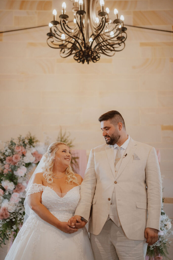 bride-and-groom-looking-at-each-other-at-the-altar-during-ceremony-rachel-and-nick-macedonian-wedding-co-hosted-by-julie-muir-at-the-peterson-house-in-hunter-valley-australia