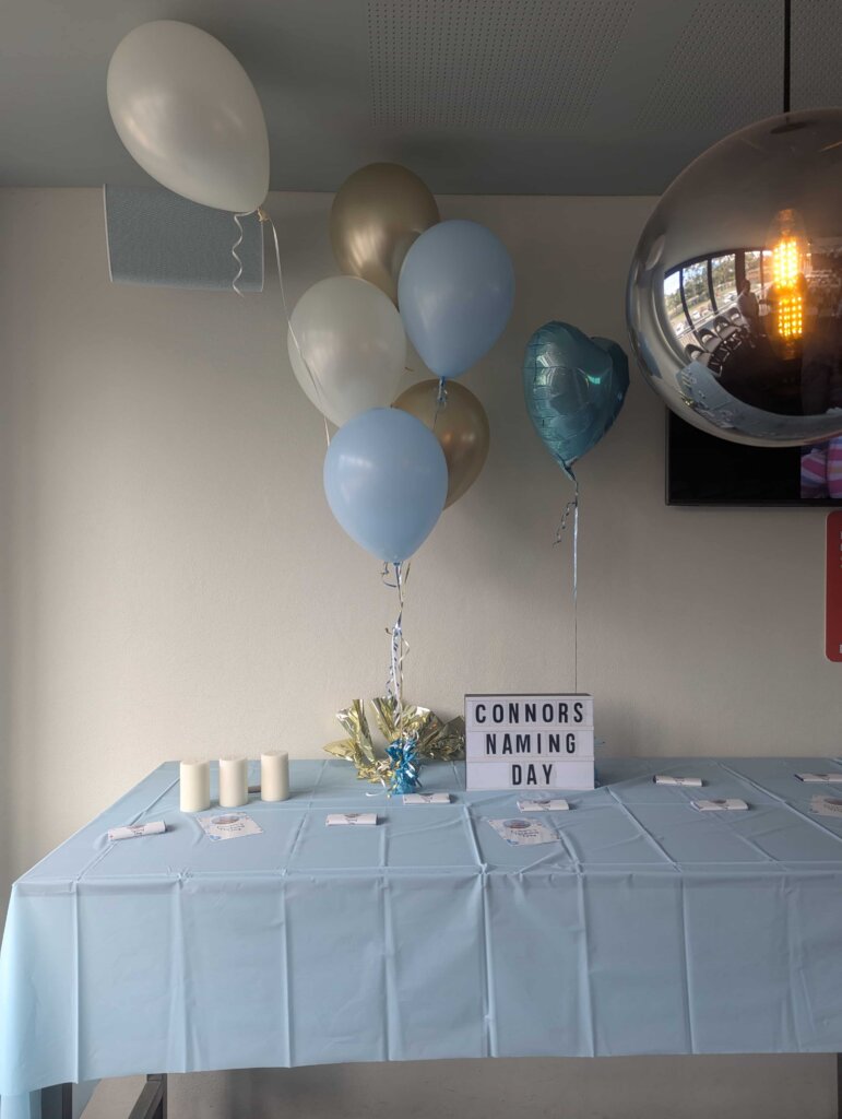 baby-naming-ceremony-simple-celebration-setup-with-white-and-blue-balloons-at-shortland-for-connor