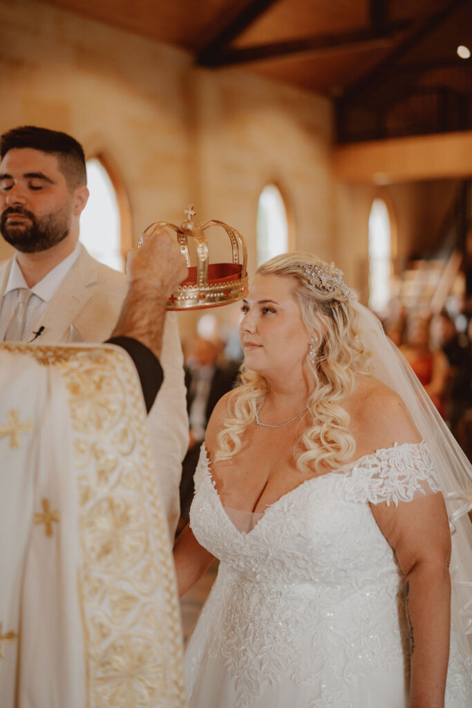 priest-crowning-the-bride-during-ceremony-rachel-and-nick