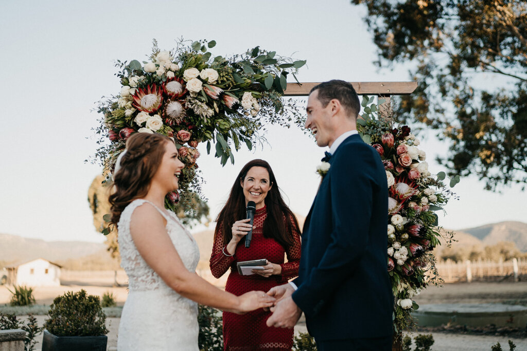keegan-and-croning-outdoor-wedding-with-a-circular-wedding-arch-decorated-with-wild-flowers-celebrated-by-julie-muir-celebrant-wedding-tax