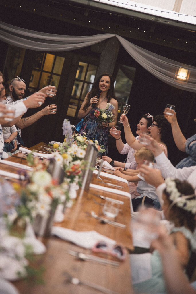 sky-and-rory-wedding-julie-muir-celebrant-giving-a-toast-captured-by-rogue-weddings-wedding-tax